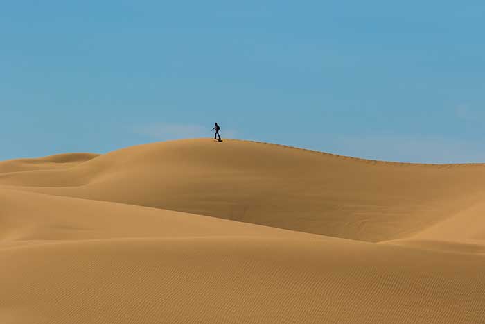 person walking in the desert
